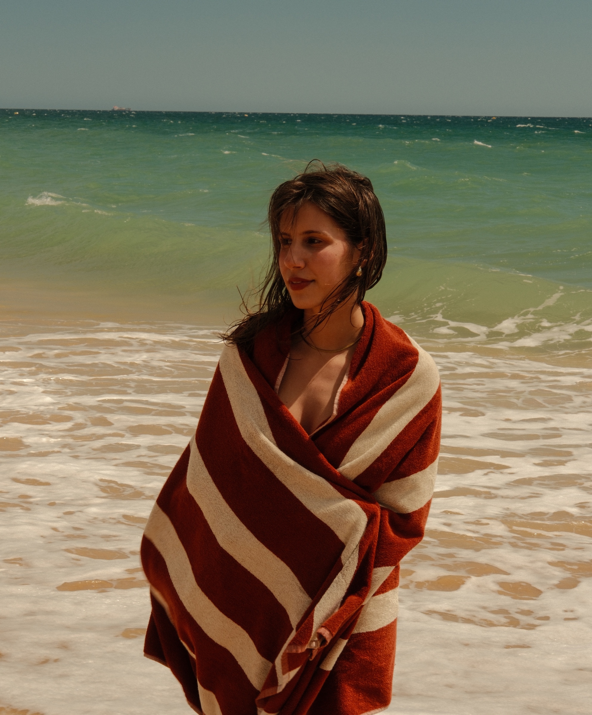brasa terracotta towel wrapped around shoulders